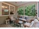 Relaxing sunroom featuring comfortable seating, a ceiling fan, and serene views of lush greenery at 1104 Snowbird Ln, Waxhaw, NC 28173