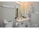 Bathroom with white vanity, toilet, and a large mirror at 1113 Geyser Ct, Fort Mill, SC 29715