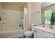 Bright bathroom featuring a tub with shower, white vanity, and toilet at 1113 Geyser Ct, Fort Mill, SC 29715