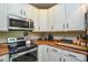 Clean kitchen featuring stainless steel appliances, ample counter space, and white cabinets at 1113 Geyser Ct, Fort Mill, SC 29715