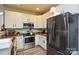 Well-lit kitchen featuring stainless steel appliances, white cabinets, and modern fixtures at 1113 Geyser Ct, Fort Mill, SC 29715