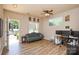 Bright living room features hardwood floors, a ceiling fan, and windows overlooking the front yard at 1113 Geyser Ct, Fort Mill, SC 29715