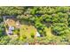 Aerial view of a beautiful wooded lot with home, garden, and large outbuilding at 120 Mossy Rock Trl, Iron Station, NC 28080