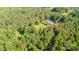 Aerial view of a house with large lawn surrounded by mature trees at 120 Mossy Rock Trl, Iron Station, NC 28080