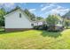 Spacious backyard featuring a well-maintained lawn and beautiful home exterior at 120 Mossy Rock Trl, Iron Station, NC 28080
