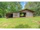 Rustic barn with open sliding doors, offering ample storage and workspace on a sprawling green lawn at 120 Mossy Rock Trl, Iron Station, NC 28080