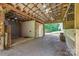 Barn interior, featuring an open layout with high ceilings, exposed beams, and convenient access to the outdoors at 120 Mossy Rock Trl, Iron Station, NC 28080