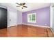 Bedroom with hardwood floors, ceiling fan, built-in closet, and plenty of natural light at 120 Mossy Rock Trl, Iron Station, NC 28080
