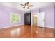 Bright bedroom offering hardwood floors, ceiling fan, natural light, and closet at 120 Mossy Rock Trl, Iron Station, NC 28080