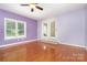 Bedroom features natural light, hardwood floors, ceiling fan, and french doors at 120 Mossy Rock Trl, Iron Station, NC 28080