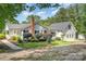 Charming home with a metal roof, featuring an inviting walkway and manicured landscaping at 120 Mossy Rock Trl, Iron Station, NC 28080