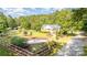 Beautifully landscaped yard with charming home, wooden fence and mature trees at 120 Mossy Rock Trl, Iron Station, NC 28080
