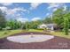 Well-manicured front yard featuring a birdbath, mature trees, and inviting walkway at 120 Mossy Rock Trl, Iron Station, NC 28080