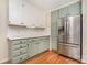 Bright kitchen showcases stainless steel refrigerator, white counters, and wood flooring at 120 Mossy Rock Trl, Iron Station, NC 28080