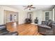 Spacious living room with a stone fireplace, wood floors, and great natural light at 120 Mossy Rock Trl, Iron Station, NC 28080