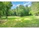 Large green yard fenced-in area, offering a secure and private outdoor space for recreation at 120 Mossy Rock Trl, Iron Station, NC 28080