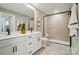 A modern bathroom features double sinks, sleek black hardware, and a glass-enclosed shower with neutral tile at 12047 Lavinia Ln, Charlotte, NC 28277