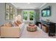 This cozy living room features a comfortable sofa, an eye-catching accent wall, and abundant natural light at 12047 Lavinia Ln, Charlotte, NC 28277