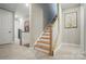 Bright staircase with carpet, white trim, wood treads, and landing with neutral paint at 12047 Lavinia Ln, Charlotte, NC 28277