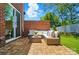 Stylish backyard patio with outdoor seating, wood-look tile, and a brick privacy wall at 12051 Lavinia Ln, Charlotte, NC 28277