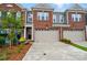 Charming townhome with a brick facade, attached garage, and well-maintained landscaping at 12051 Lavinia Ln, Charlotte, NC 28277