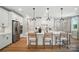 Bright, open kitchen featuring white cabinets, stainless steel appliances and a center island with seating at 12051 Lavinia Ln, Charlotte, NC 28277
