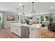 Open concept kitchen with a large island, stainless steel appliances, and connection to the living room at 12051 Lavinia Ln, Charlotte, NC 28277