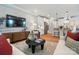 Open concept living room with stainless steel appliances, bar seating, large TV, and modern furnishings at 12051 Lavinia Ln, Charlotte, NC 28277