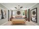 Stylish main bedroom with a ceiling fan, decorative wall art, a upholstered headboard and bench at 12051 Lavinia Ln, Charlotte, NC 28277