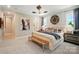 Bright main bedroom features a ceiling fan, a upholstered headboard, bench, and neutral decor at 12051 Lavinia Ln, Charlotte, NC 28277