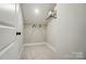 A compact walk-in closet with neutral walls, carpeted floors, and white wire shelving for organized storage at 12051 Lavinia Ln, Charlotte, NC 28277