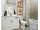 Stylish bathroom features a tub with a shower, gray tile and a single sink vanity at 12055 Lavinia Ln, Charlotte, NC 28277
