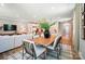 Bright, open-concept dining area with wooden table and decorative leafy centerpiece near living area at 12055 Lavinia Ln, Charlotte, NC 28277