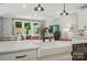 Kitchen island with white countertop, black faucet, and stainless dishwasher at 12055 Lavinia Ln, Charlotte, NC 28277