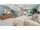 Spacious main bedroom featuring a sloped ceiling, neutral decor, and a cozy seating area by the bright window at 12055 Lavinia Ln, Charlotte, NC 28277