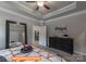 Comfortable bedroom with a trey ceiling, black dresser, and large mirror at 1260 Langston Ln, Salisbury, NC 28144