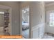 Inviting bedroom with a ceiling fan, neutral paint, and an adjacent bathroom with tub at 1260 Langston Ln, Salisbury, NC 28144