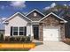 Charming single-Gathering home featuring stone accents, a one-car garage, and a well-manicured lawn at 1260 Langston Ln, Salisbury, NC 28144