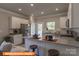 Open kitchen features stainless steel appliances, granite countertops, a center island, and a dining area at 1260 Langston Ln, Salisbury, NC 28144