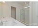 Bright bathroom featuring double sinks, quartz countertop, glass shower, and sleek fixtures at 1278 Langston Ln, Salisbury, NC 28144