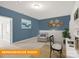 Comfortable bedroom featuring blue accent wall, decorative shelving, and a cozy reading nook at 1278 Langston Ln, Salisbury, NC 28144