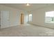 Large bedroom featuring neutral carpeting, two windows and crisp, neutral paint at 1278 Langston Ln, Salisbury, NC 28144