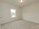 Bright bedroom featuring neutral carpeting, fresh paint, and a view of the neighborhood at 1278 Langston Ln, Salisbury, NC 28144