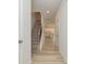 Bright hallway with wood flooring, leading to a staircase and a modern kitchen with white cabinets at 1278 Langston Ln, Salisbury, NC 28144