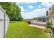 A large backyard with a white fence and a multi-tiered deck from the back of the home at 13223 Willow Breeze Ln, Huntersville, NC 28078