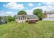 Large backyard with trees, green grass, wooden deck, and a screened in porch at 13223 Willow Breeze Ln, Huntersville, NC 28078
