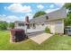 Backyard view features a deck, screened porch, and well maintained lawn and garden at 13223 Willow Breeze Ln, Huntersville, NC 28078