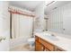 A charming bathroom offers a sink with wood cabinets and tub with floral accents at 13223 Willow Breeze Ln, Huntersville, NC 28078