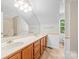 A bathroom offers a double sink vanity, a mirror, and shower and toilet areas at 13223 Willow Breeze Ln, Huntersville, NC 28078