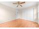 A bright bedroom features a ceiling fan, hardwood floors, and a double door closet at 13223 Willow Breeze Ln, Huntersville, NC 28078